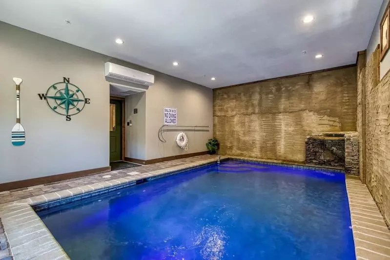 indoor pool inside Splashin Chalet 6 bedroom cabin in Pigeon Forge