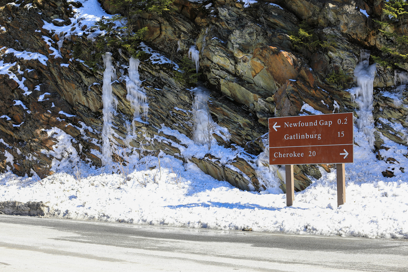 Newfound Gap Road in winter with snow and icicles next to road